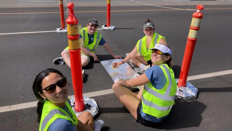 Researchers collect road dust samples from a section of road paved with recycled plastic-reinforced asphalt. Pictured left to right: Rachel Nakamoto, Simon Williams, Cara Megill and Cate Wardinski