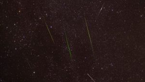 Meteor streaking across a starry sky