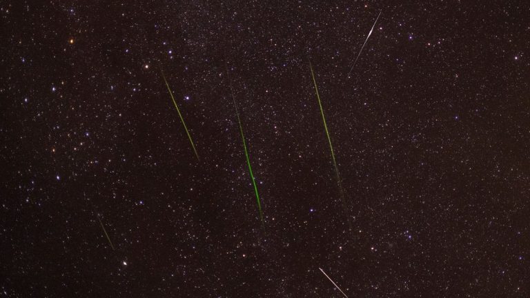 Meteor streaking across a starry sky
