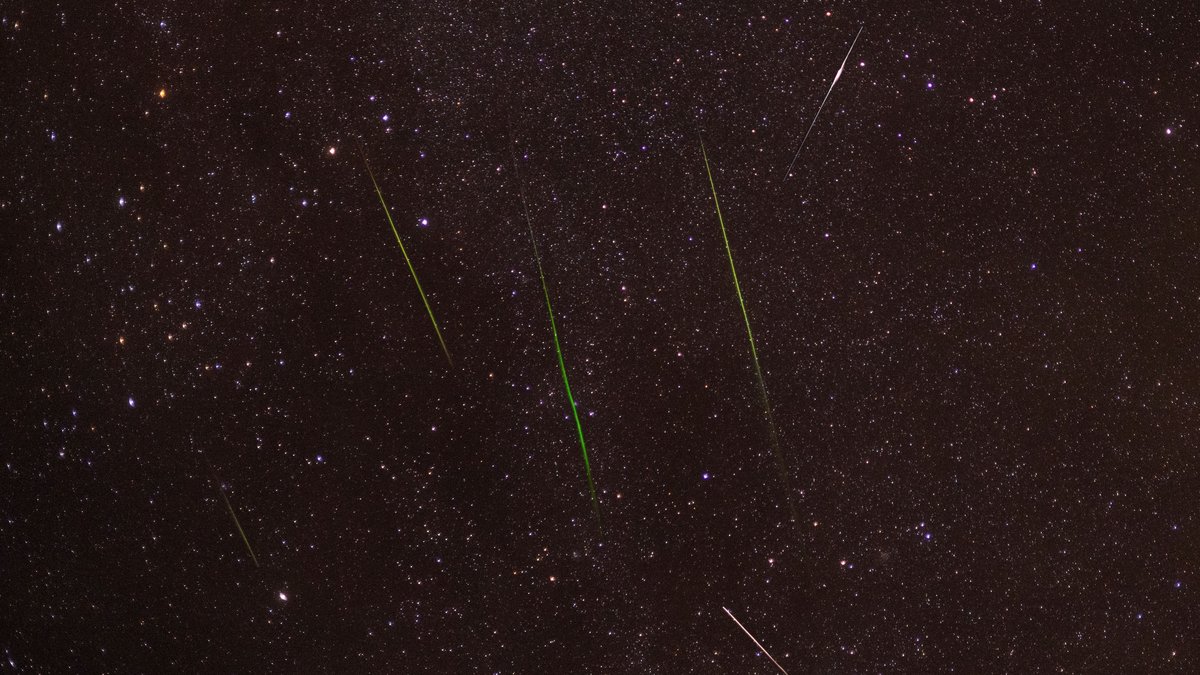 Meteor streaking across a starry sky