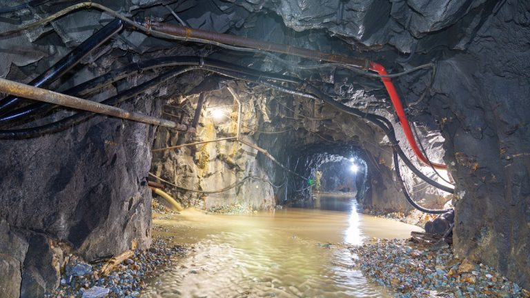 Underground mine tunnel with flowing water