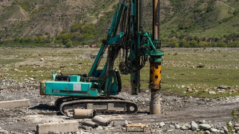 A heavy drilling machine working on a rugged geological site