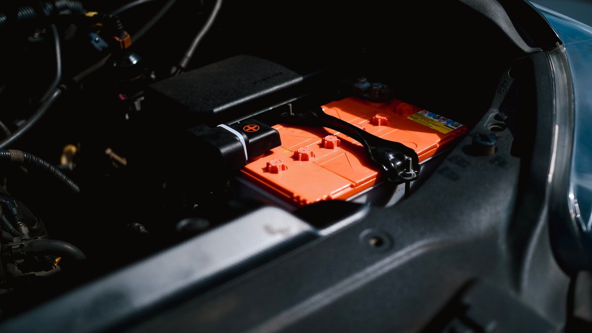 Detailed view of an electric car battery inside a vehicle's engine compartment, highlighting sustainable technology