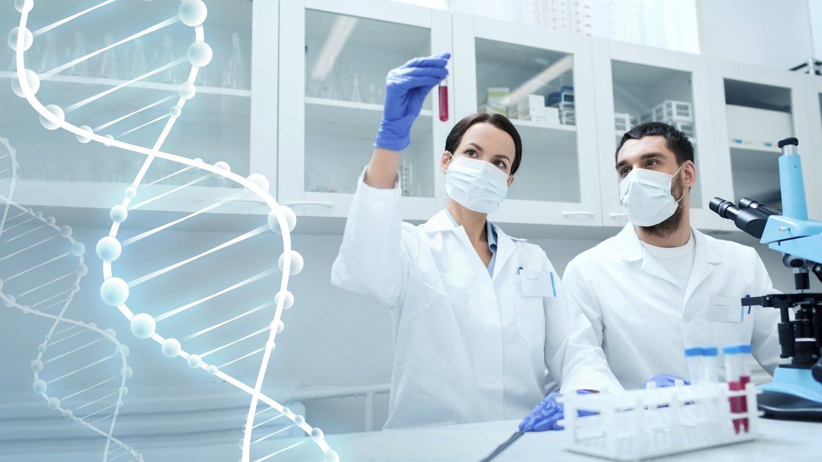 Science, chemistry, technology, biology and people concept - young scientists with test tube and microscope making research in clinical laboratory