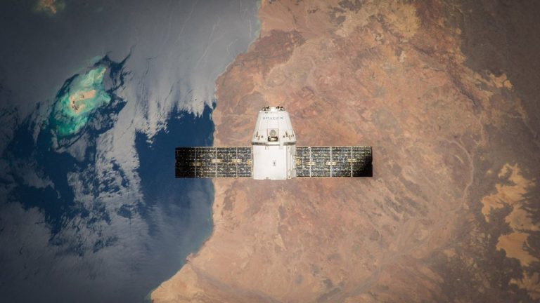 Satellite in orbit with detailed view of Earth and ocean below