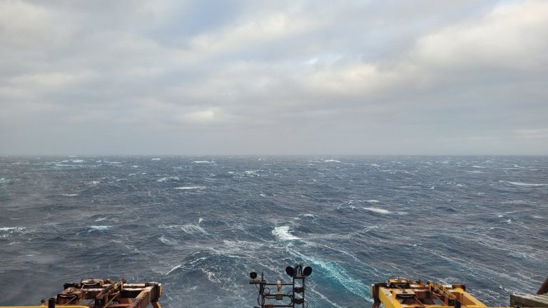 View of the vast ocean and horizon from an offshore platform under cloudy skies