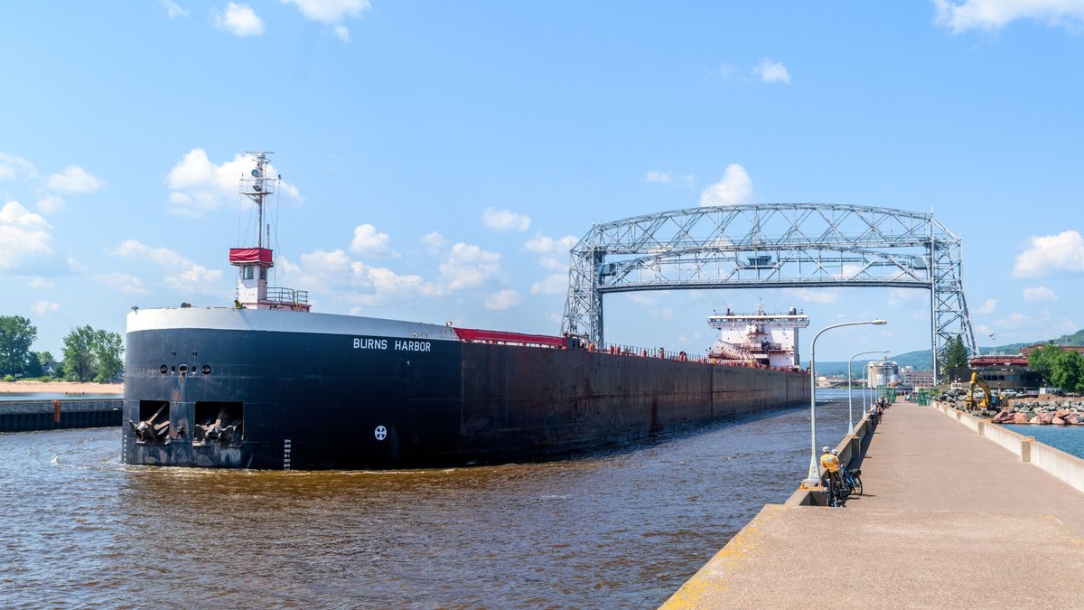 Cargo ship passing beneath the Aerial Lift Bridge on the Great Lakes waterway at Duluth