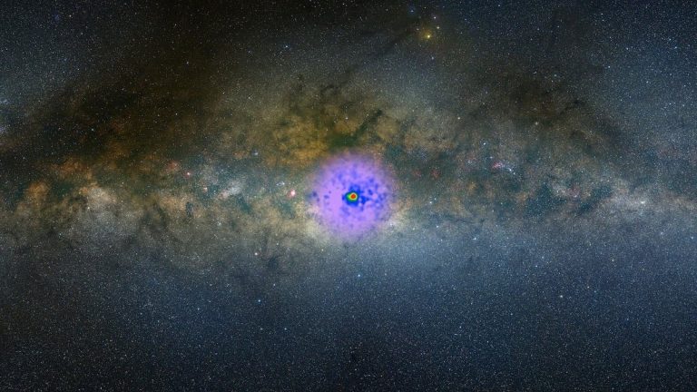 An image of the gamma-ray excess observed at the center of the Milky Way, overlaid on an optical image of the galaxy. Scientists have debated the origin of this excess, and whether it could be caused by dark matter, for more than a decade