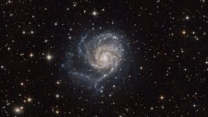 Spiral galaxy with bright arms in deep space