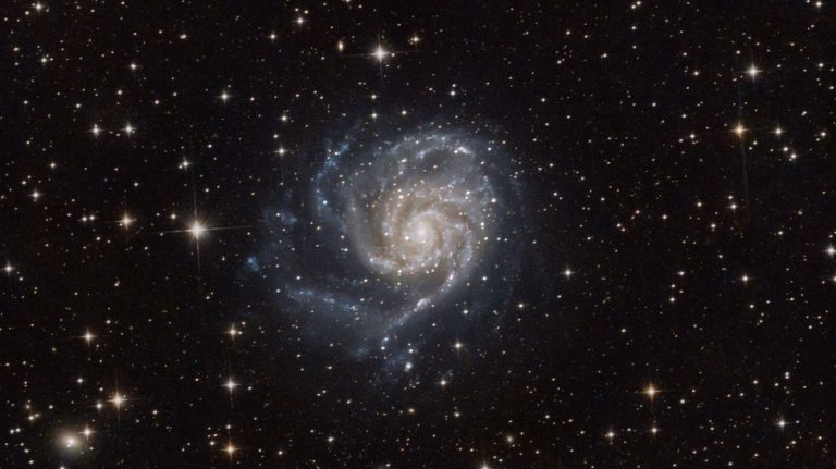 Spiral galaxy with bright arms in deep space