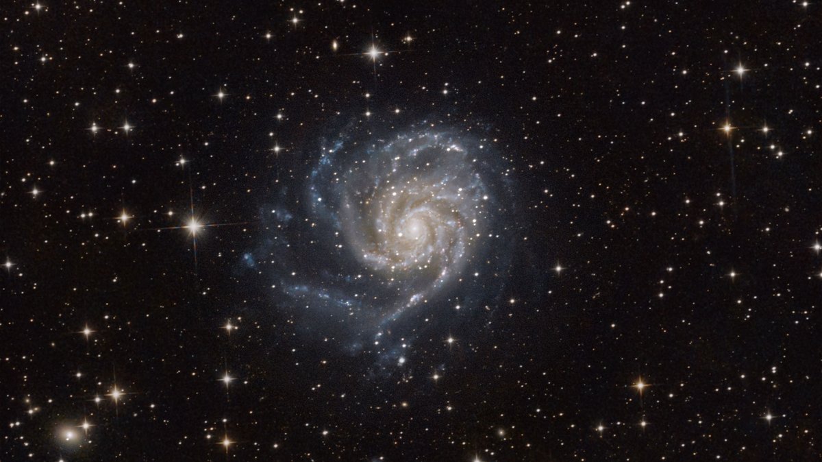 Spiral galaxy with bright arms in deep space
