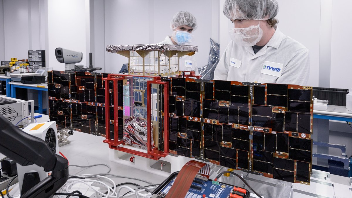 Engineers prepare the CAPSTONE spacecraft during assembly and testing