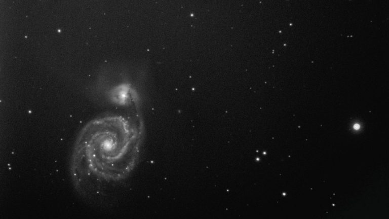 A captivating black and white image of a spiral galaxy in the expansive cosmos