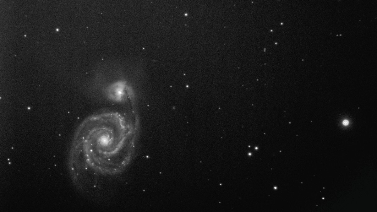 A captivating black and white image of a spiral galaxy in the expansive cosmos