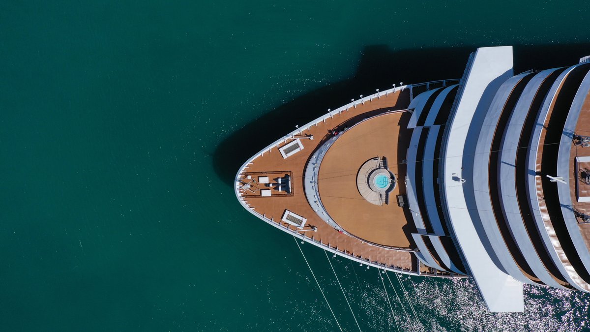 Aerial top view photo of huge cruise ship docked in mediterranean port destination
