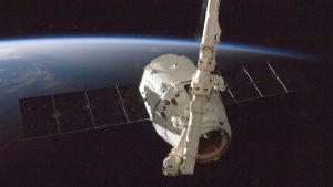 A satellite orbiting Earth with a view of the planet from space