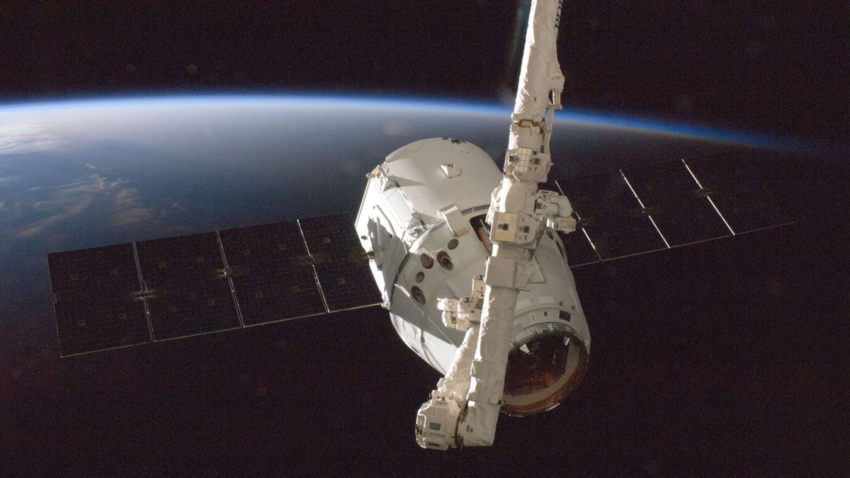 A satellite orbiting Earth with a view of the planet from space