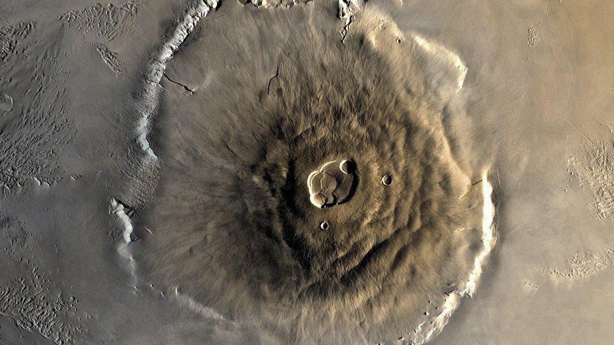 Olympus Mons volcano on Mars shown as a broad shield volcano on the red planet