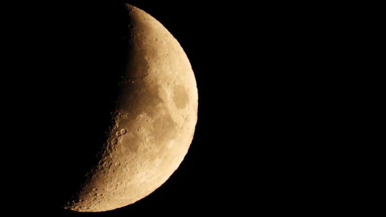 Extreme zoom of half moon as seen at night