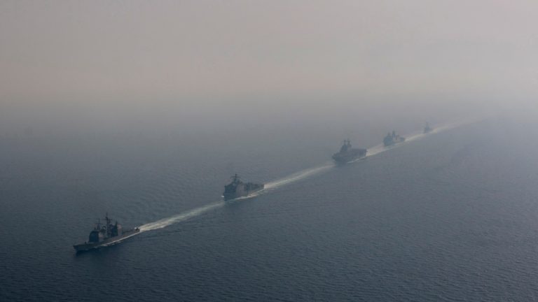 Five U.S. Navy ships transiting the Strait of Hormuz in formation