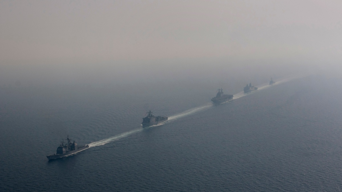 Five U.S. Navy ships transiting the Strait of Hormuz in formation