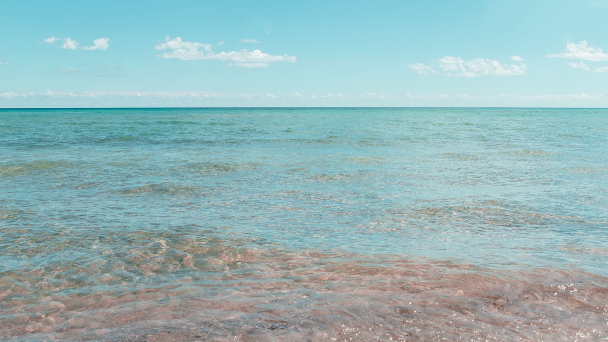 Tranquil shoreline scene with clear skies at East Tawas, Michigan, USA