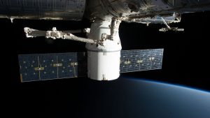 Image of the International Space Station floating above Earth with visible solar panels