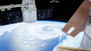A mesmerizing view of Earth as seen from a space station with solar panels and satellite modules