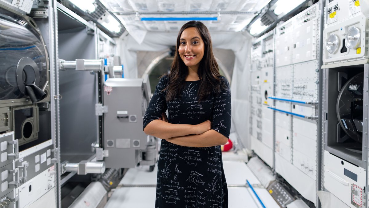 A smiling female scientist in a futuristic space station, symbolizing innovation and exploration