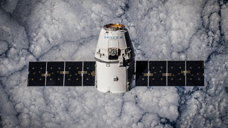 SpaceX Dragon spacecraft in orbit, highlighting advanced space technology with cloud backdrop