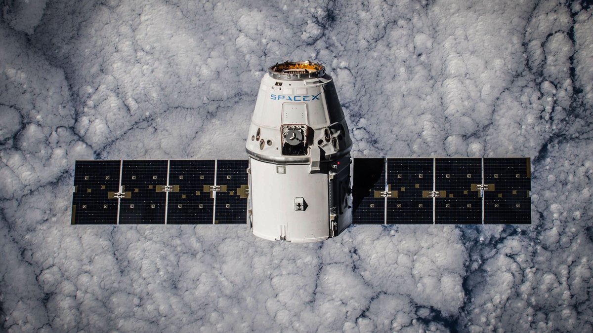 SpaceX Dragon spacecraft in orbit, highlighting advanced space technology with cloud backdrop