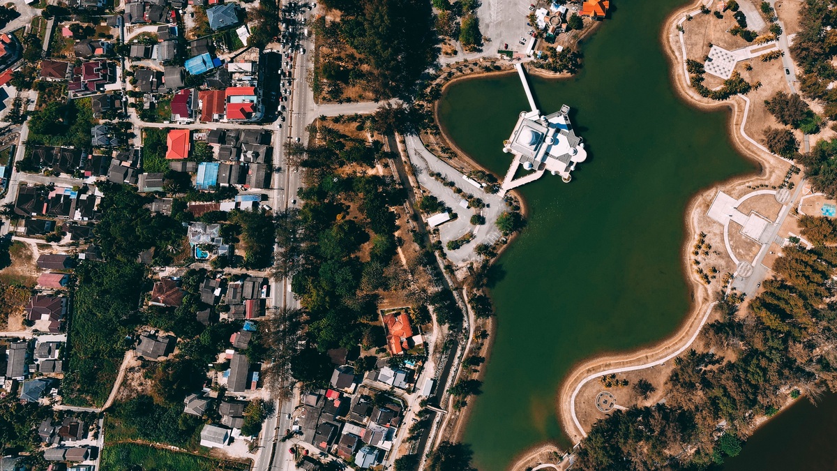 An aerial photo showcasing a vibrant urban landscape adjacent to a serene lake
