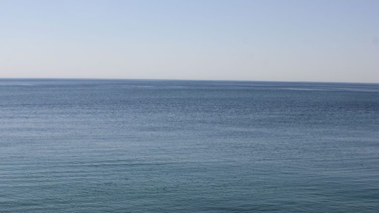 Tranquil view of Lake Ontario's serene blue waters and horizon, capturing peace and calm