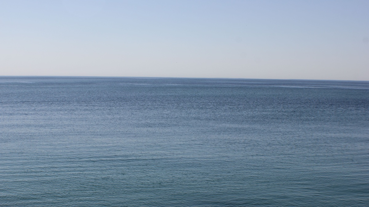Tranquil view of Lake Ontario's serene blue waters and horizon, capturing peace and calm