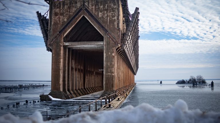 A stunning view of the abandoned ore dock in a snowy winter landscape by Lake Superior in Marquette, MI