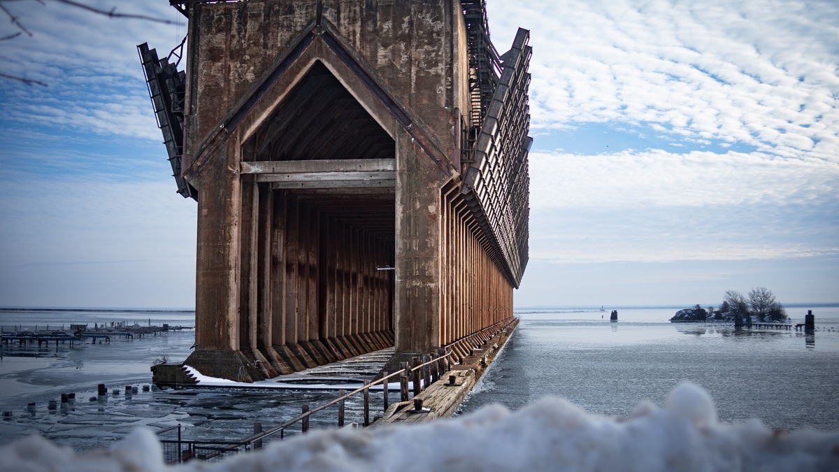 A stunning view of the abandoned ore dock in a snowy winter landscape by Lake Superior in Marquette, MI