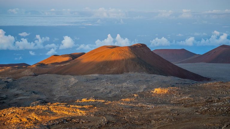 The volcanic summit landscape of Mauna Kea in Hawaii at sunset
