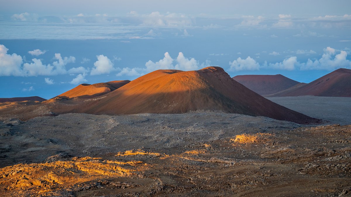 The volcanic summit landscape of Mauna Kea in Hawaii at sunset