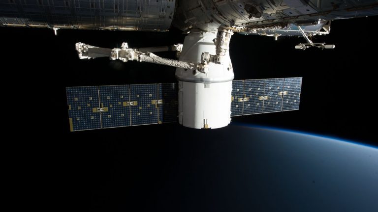 A SpaceX satellite hovering over Earth's horizon in outer space, showcasing advanced space technology