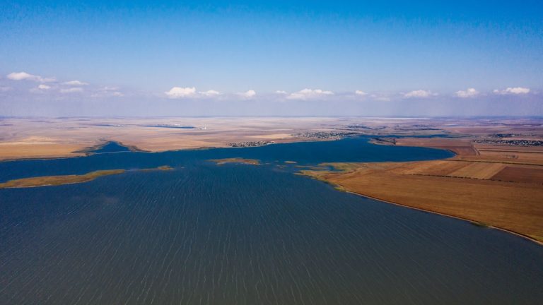 A large reservoir surrounded by open land, viewed from above