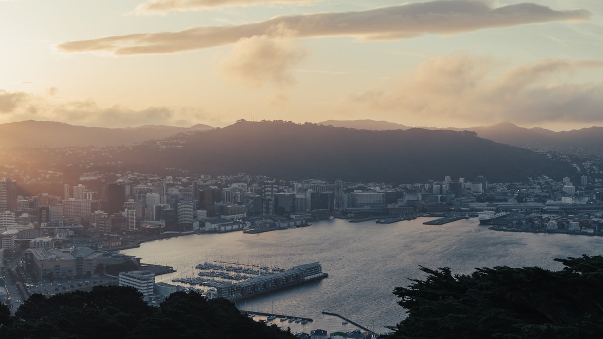 An aerial view of Wellington, New Zealand and its ocean waterfront at sunset