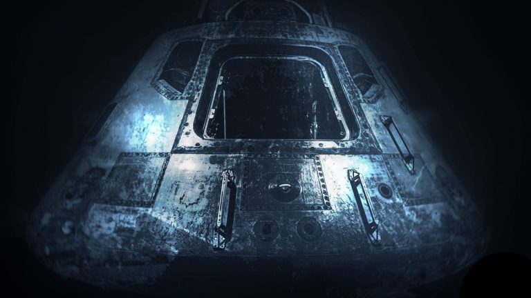 A dramatic monochrome image of an old space capsule in dim light, showcasing space exploration history