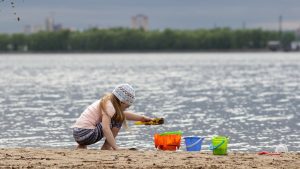Child_playing_at_freshwater_lake_beach