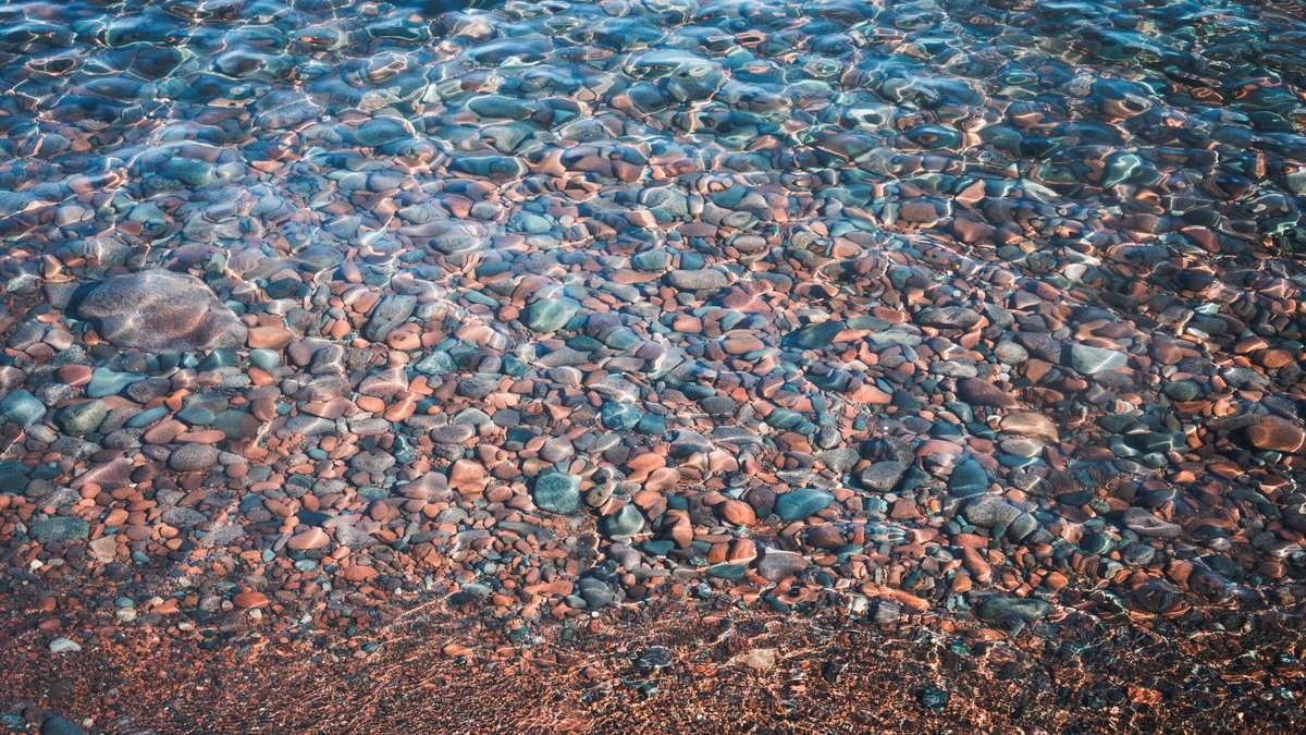 Vibrant stones beneath the clear waters of Lake Superior in Duluth, Minnesota