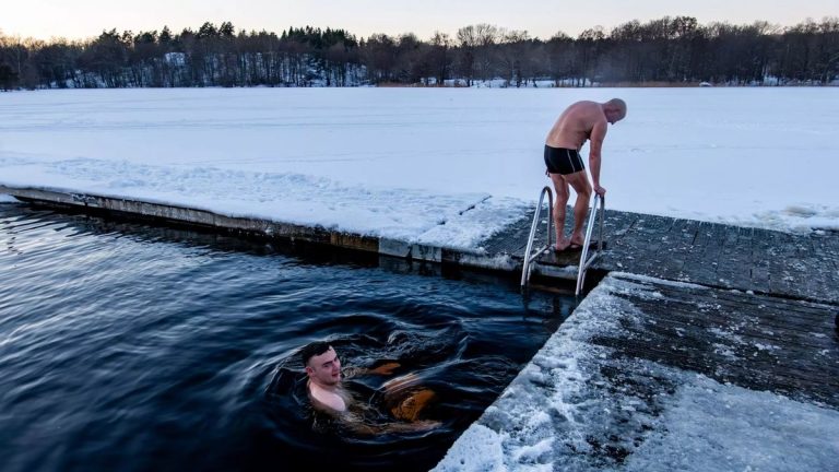 Cold water swimmers entering an icy lake