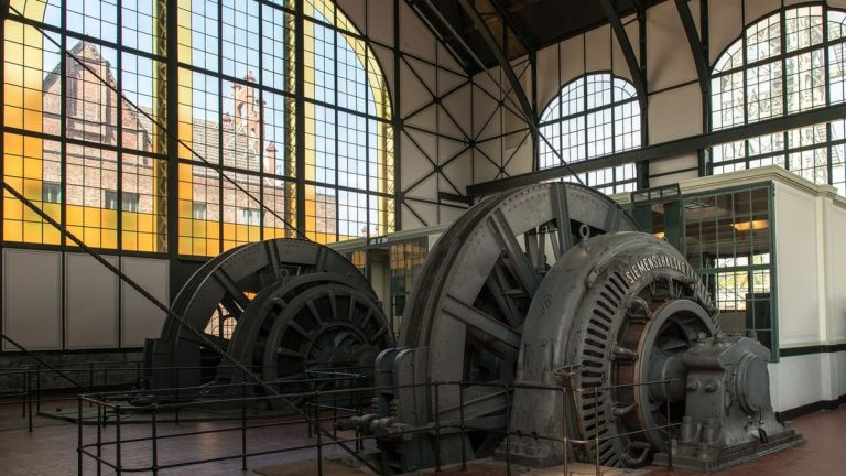 Interior view of the engine room in the Zollverein Coal Mine, showcasing historic machinery and large windows