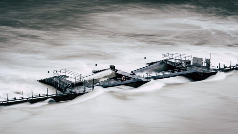 An aerial view of a structure overwhelmed by a river flood in Bern, Switzerland
