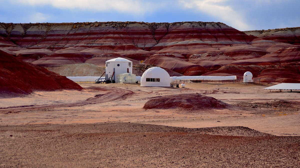 A remote research habitat in a barren Mars-like desert landscape