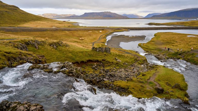 A breathtaking aerial view of a pristine Icelandic landscape featuring a flowing river and serene lake