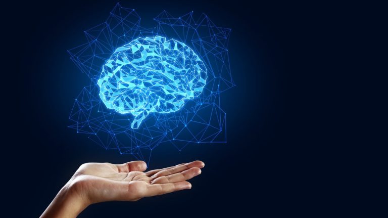 Hand holding creative glowing polygonal brain on blue background. AI and future concept